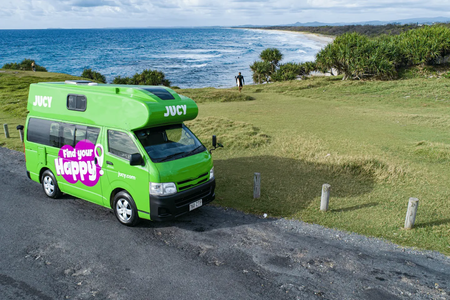 Jucy green campervan parked at a coastal lookout