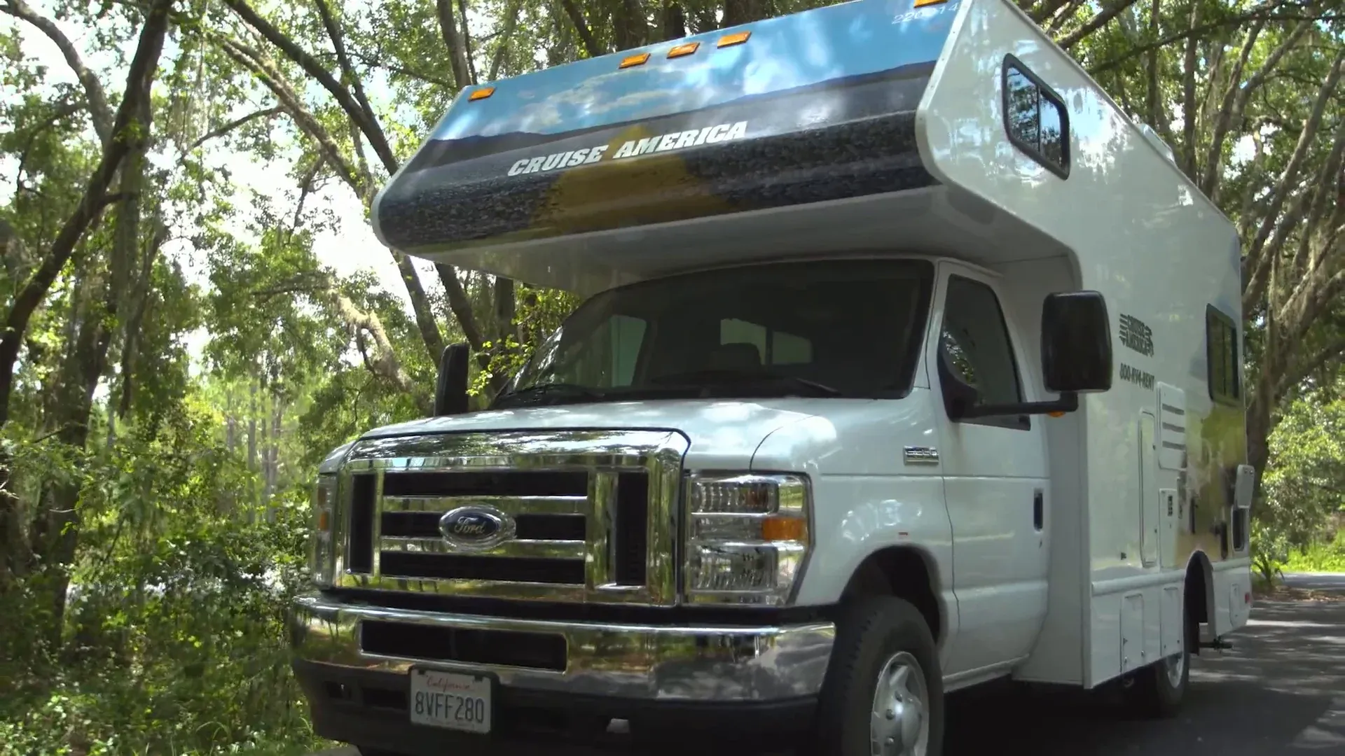 Cruise America motorhome parked under trees