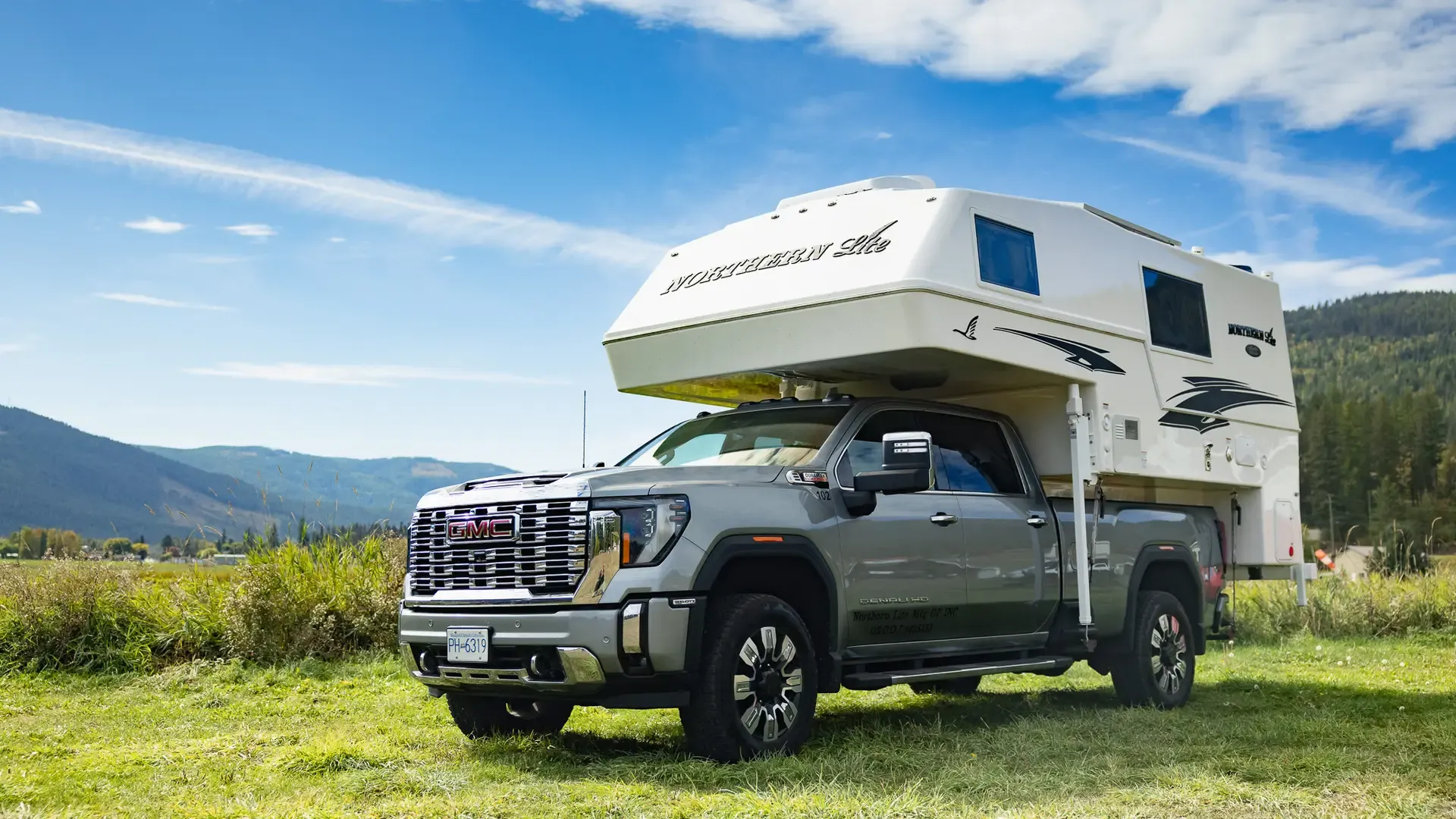 Truck camper parked in a mountain valley in British Columbia