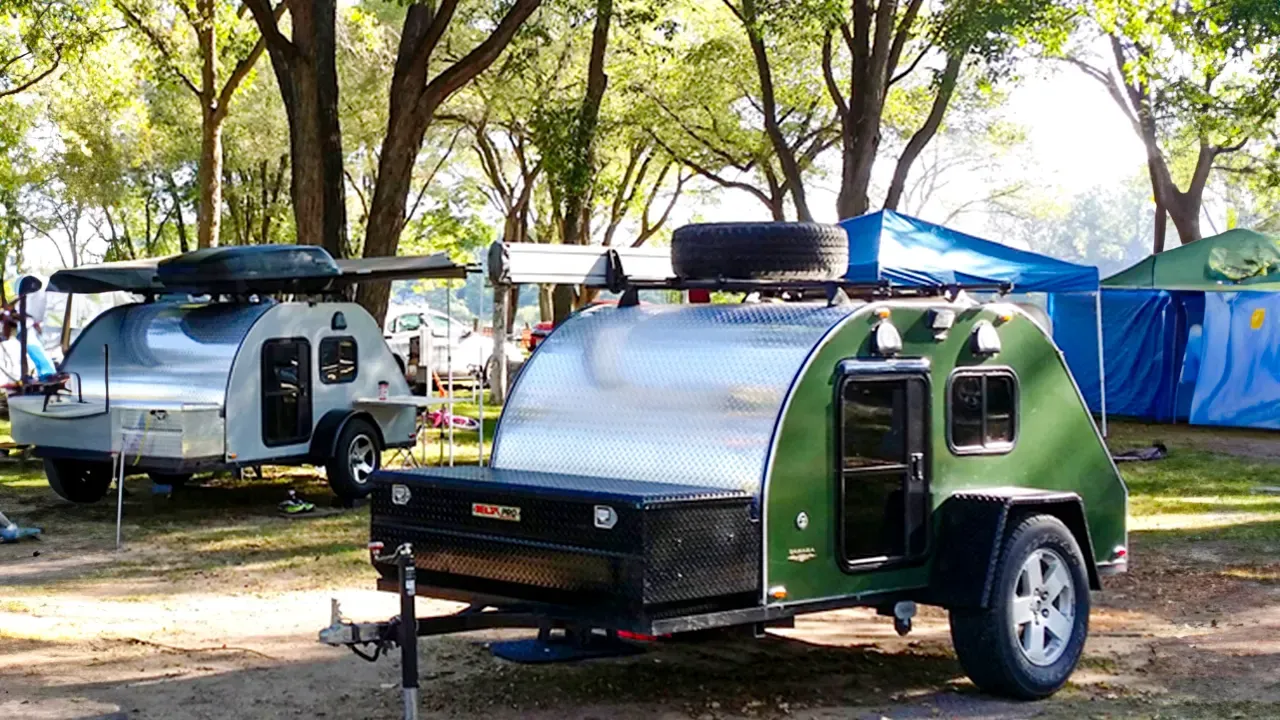 Teardrop trailers parked at a shaded campground